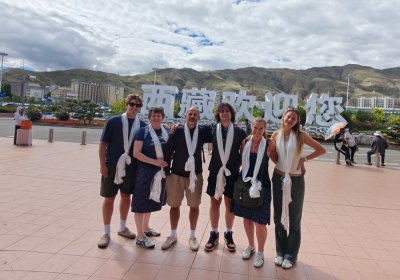 Traveler photo: Fresh off the plane, guests take their first group photo at the airport—under perfect plateau sunlight. (July 2026)