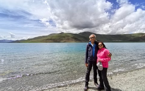 Traveler photo: Two guests share a loving smile by the sacred lake, capturing this highland journey in a warm group photo. (July 2026)
