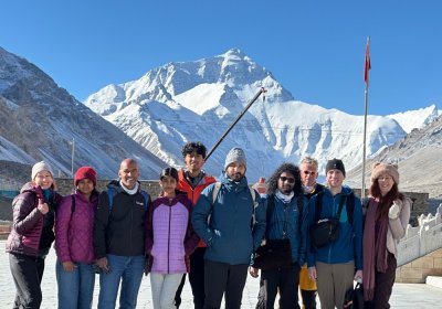 Traveler photo: Smiling in front of Everest, the guests take a precious group photo, with the snowy peak as witness to their journey. (July 2026)