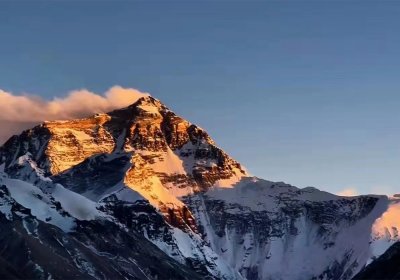 Traveler photo: Sunset casts a golden glow over the summit of Mount Everest. (July 2026)	