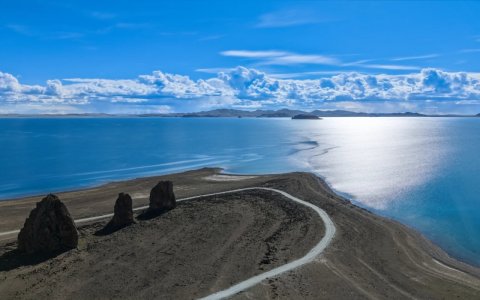 Traveler photo: From above, Namtso Lake gleams like a giant sapphire set between snow mountains and grasslands. (July 2026)