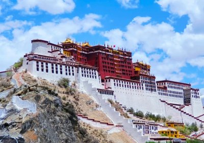 Traveler photo: Potala Palace stands in central Lhasa, its red and white walls with golden roofs striking under the blue sky. (July 2026)