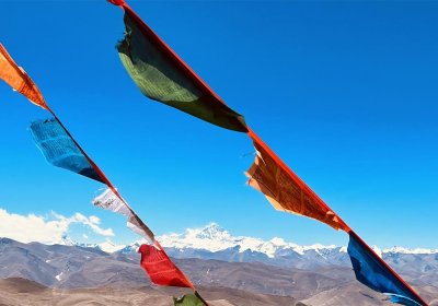 Traveler photo: At Gawula Pass, prayer flags flutter in the wind against the snow-capped mountains. (Jun 2025)