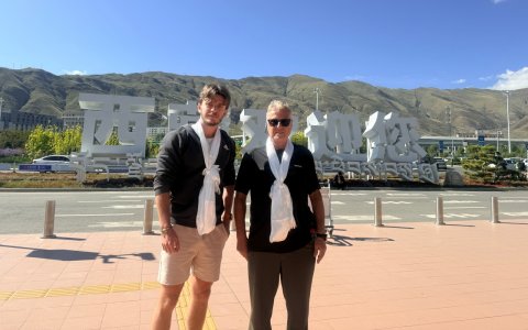 Traveler photo: We warmly welcome two guests from afar at the airport, offering pure white khata scarves. (June 2026)
