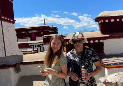 Traveler photo: Two guests slow down in Lhasa's streets, soaking in the everyday atmosphere of this sacred city. (June 2026)