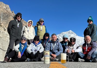 Traveler photo: Guests pose for a proud group photo with Mount Everest behind them under the clear blue sky. (June 2026)