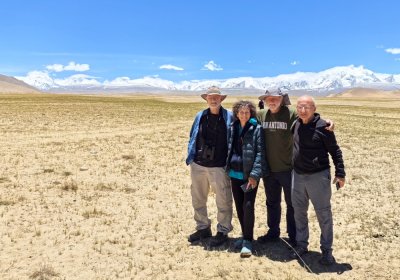 Traveler photo: On the highway to Shigatse, guests pose with vast grasslands behind them—a natural travel keepsake. (June 2026)