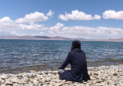 Traveler photo: Our beloved guest meditates along the shore of Namtso lake, one of the highest lakes in the world. (June 2026)	