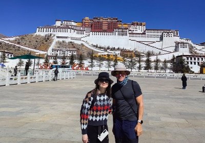 Traveler photo: On Lhasa's Potala Square, the smiles of two guests are framed together with the sacred snowy sanctuary. (March 2026)