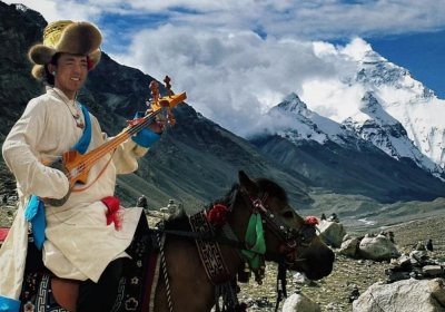 Traveler photo: At the foot of Mount Everest with local Tibetans - sharing smiles beneath the world’s highest peak. (May 2025)	