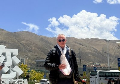 Traveler photo: We warmly welcome a guest from afar at the airport, offering a pure white khata scarf. (May 2026)