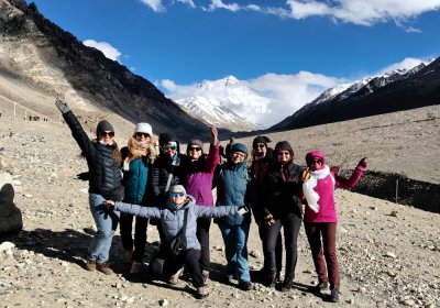 Traveler photo: Guests line up for a group photo at Everest Base Camp, with the world's highest peak standing tall behind them. (May 2026)