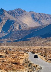 Traveler photo: On the national highway in Shigatse, Tibet, an off-road vehicle drives toward the endless mountains. (November 2025)