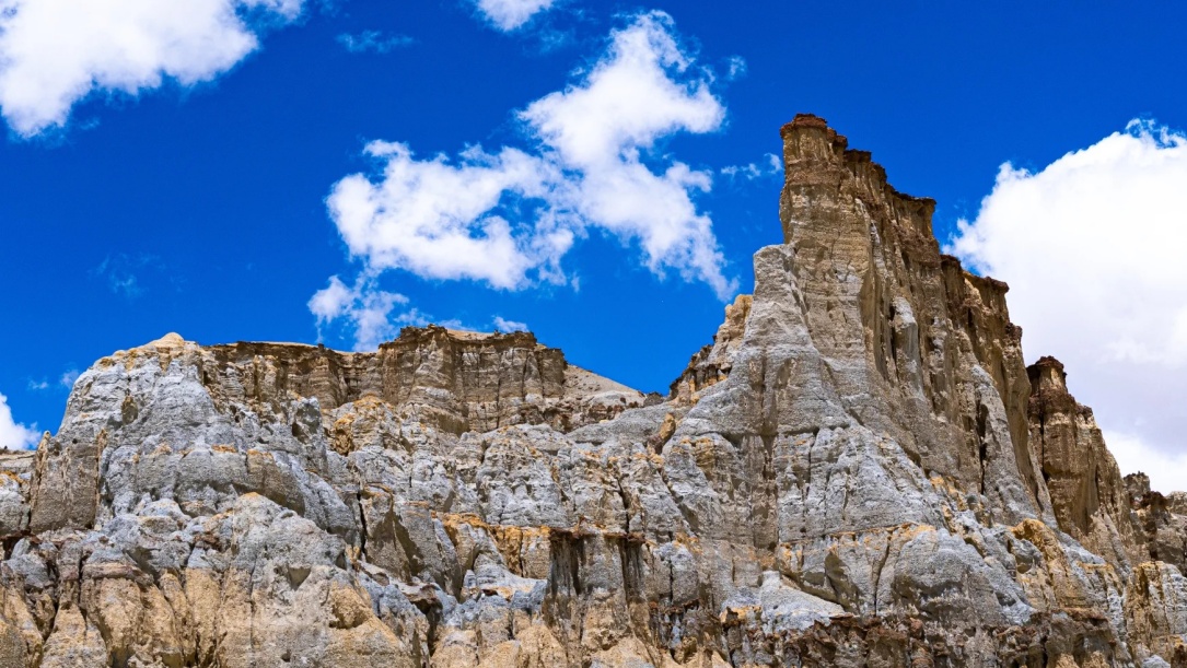 White clay ruins under bright blue sky