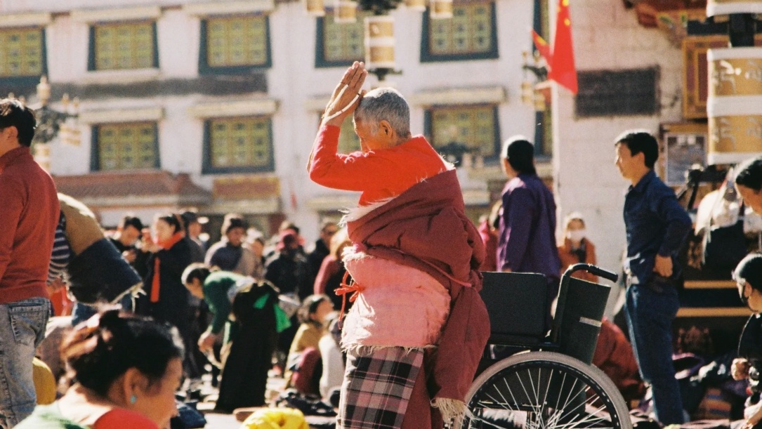 Locals pray on the Barkhor Street