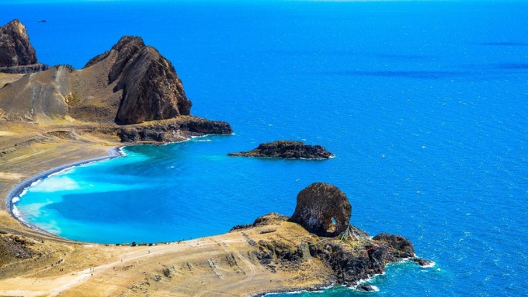 Turquoise Namtso Lake water with rocky shore
