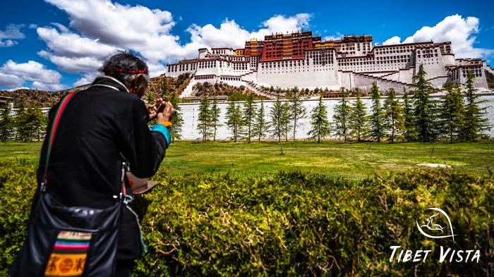 Local Tibetans making a pilgrimage before the Potala Palace