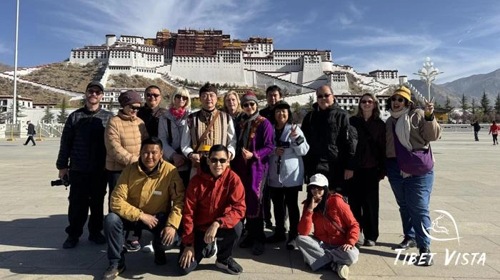 Tourists taking photos in Potala Palace Square in winter