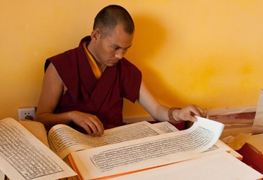 A Tibetan Lama is working in the scripture printing house at Nartang Monastery.