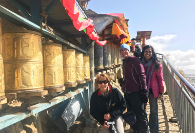 Turning prayer wheel in Tashilhunpo Kora