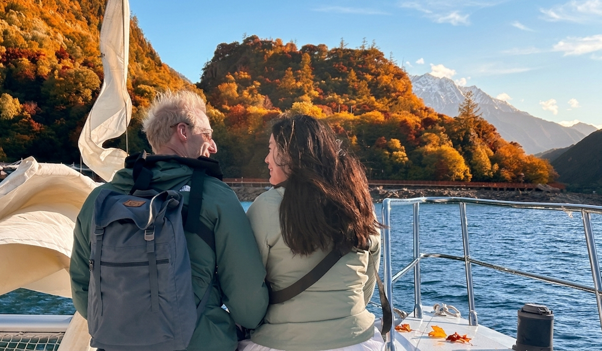 cruise across the sapphire waters of basum tso lake and golden forests in autumn