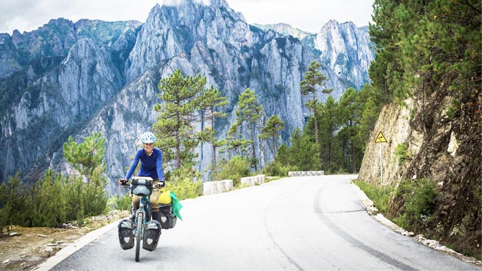 A Young Female Cyclist on Her Bike Trip along the Xinjiang-Tibet Highway