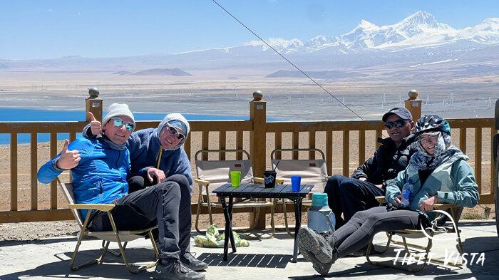 Our bike riders enjoy Tibetan sweet tea stop at sapphire-blue Peikutso Lake