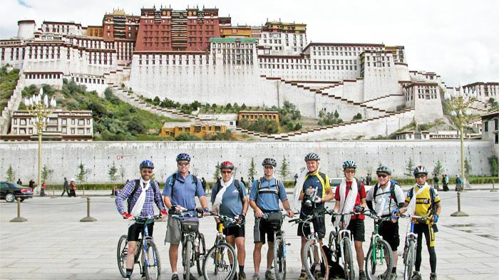 Cyclists Take Photos in Front of Potala