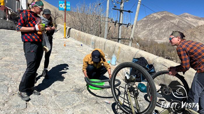 our team fixing mountain bike tires in Tibet