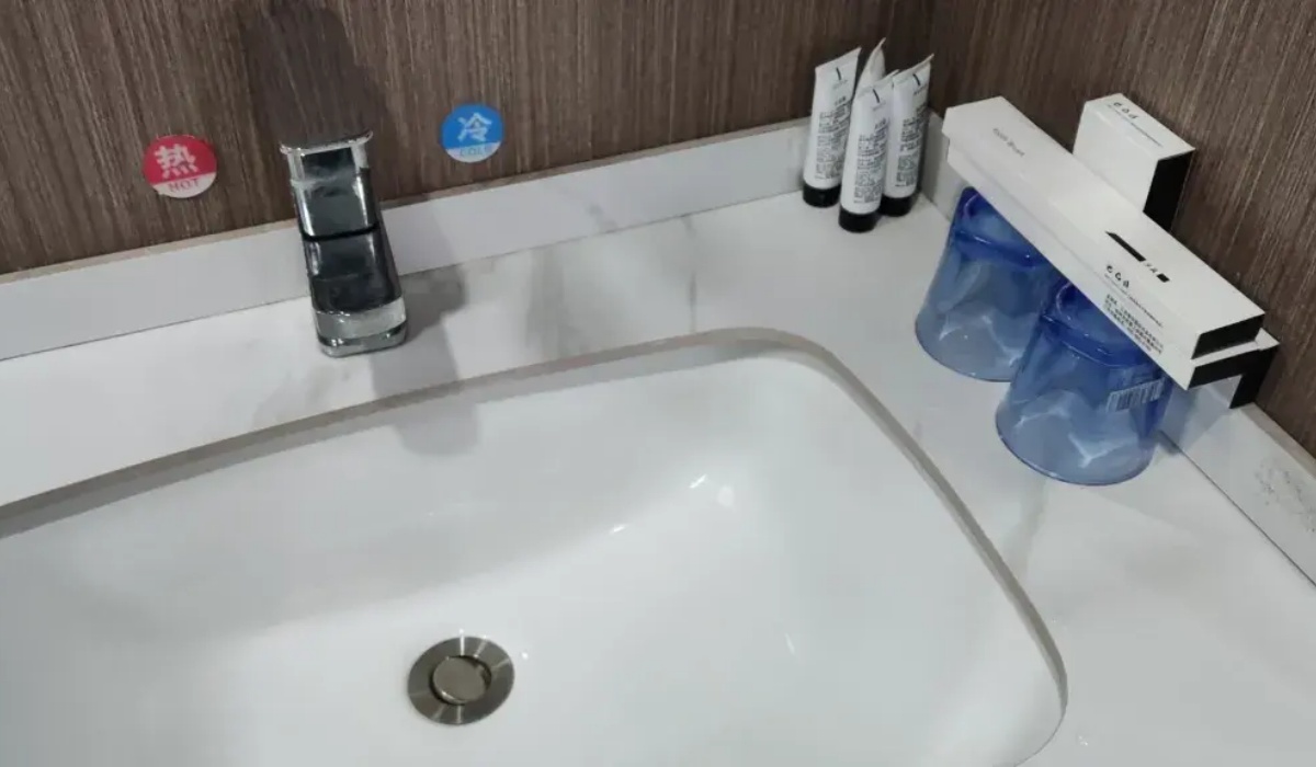 Clean bathroom vanity sink with complimentary toiletries