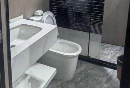 Modern bathroom with marble vanity and toilet at Letu Hotel Darchen