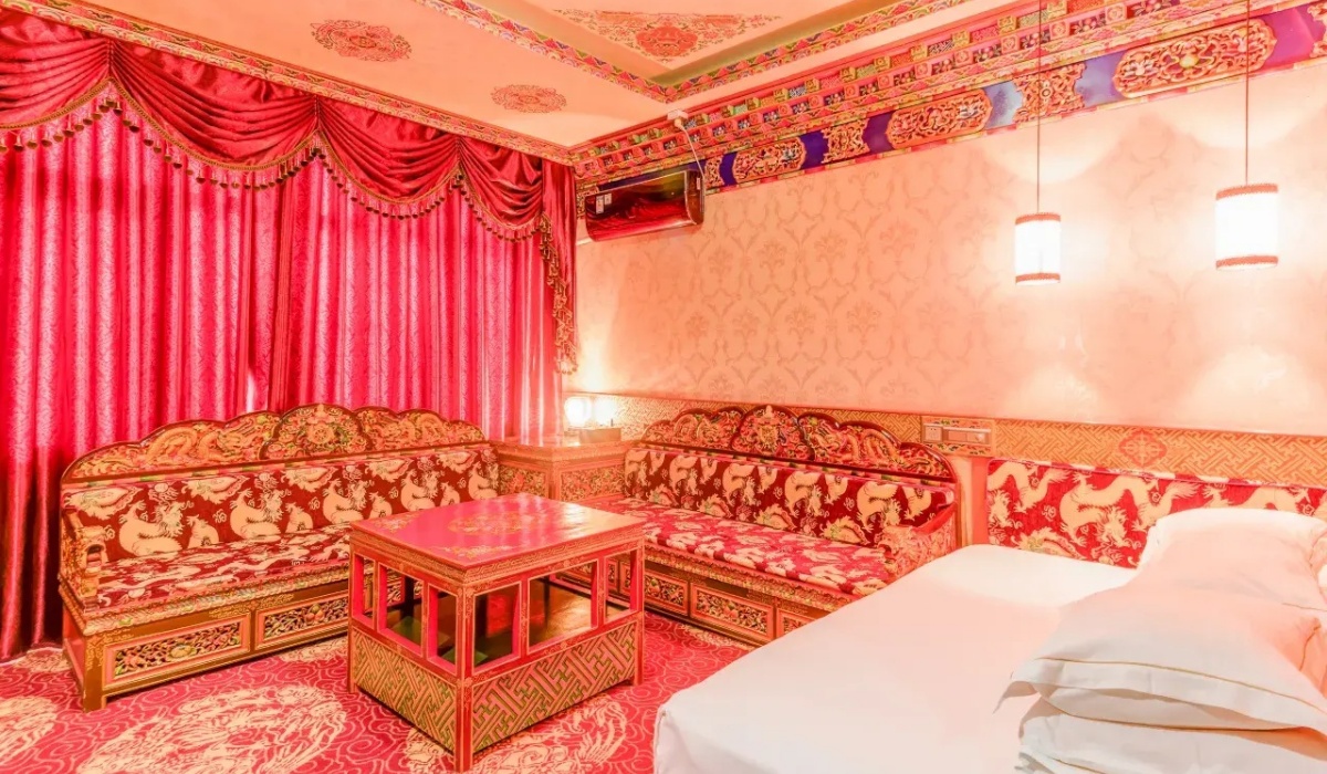 Tibetan style deluxe suite with traditional red drapery and sofa