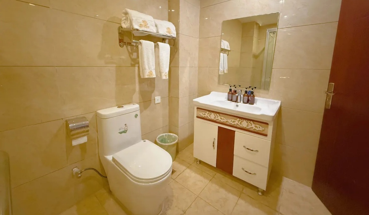 Guest room bathroom with toilet and vanity unit