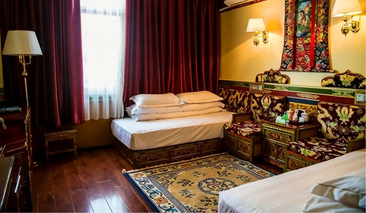 Traditional Tibetan guest room with bed sofa and thangka painting