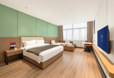 King bed guest room featuring seating area and mountain view window at QoMoLangZong Hotel Kayrung