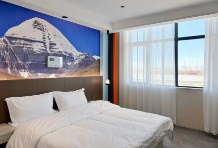 Cozy king bedroom featuring Mount Kailash wall mural at Shenling Mountain Hotel