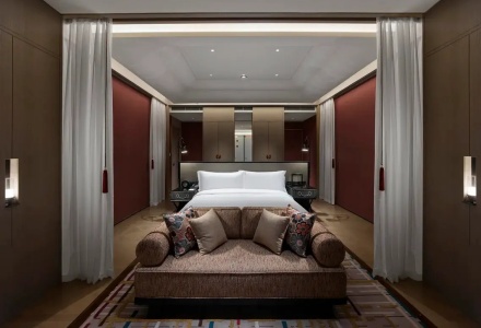 Elegant king room featuring a comfortable lounge sofa and traditional decor