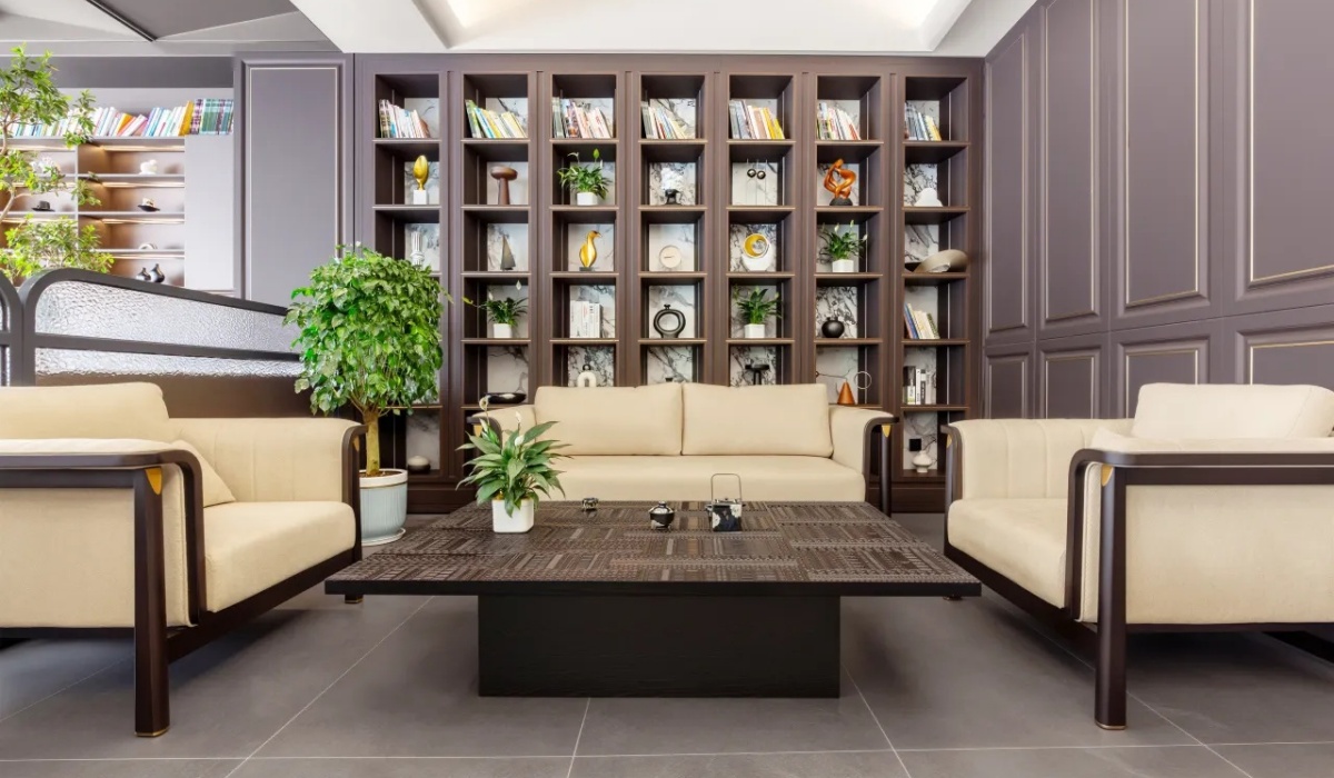 Lobby reading area next to a wooden bookshelf