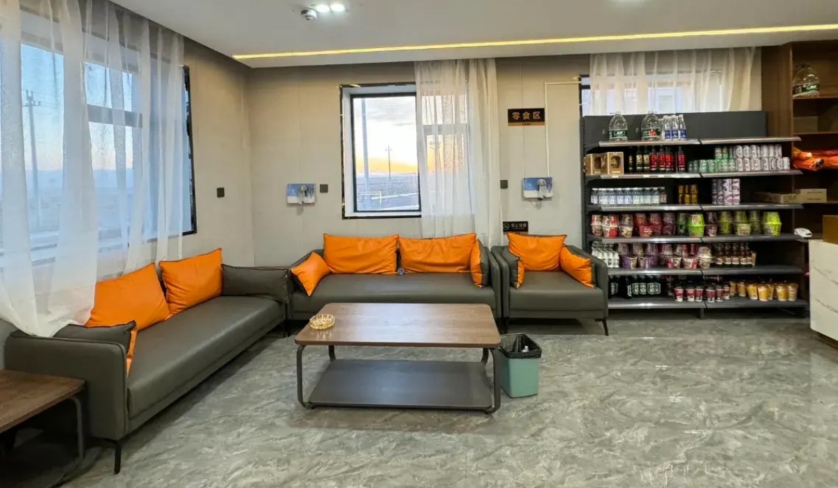 Lobby lounge with comfortable sofa seating and snack shelf at Letu Hotel