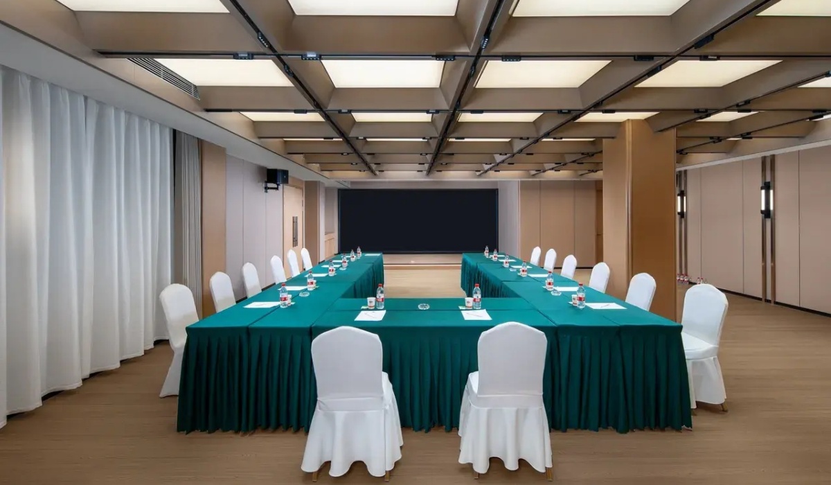 Spacious hotel meeting room setup for conference