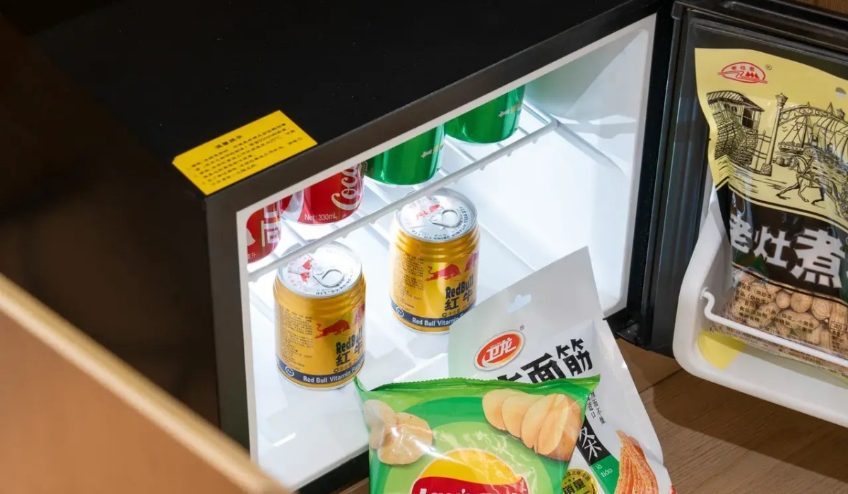 In-room mini fridge stocked with drinks and snacks