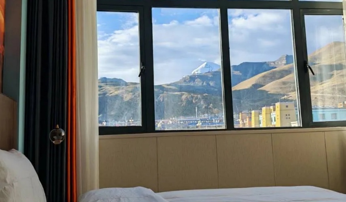 Mountain view through raindrop glass window at Shenling Mountain Hotel