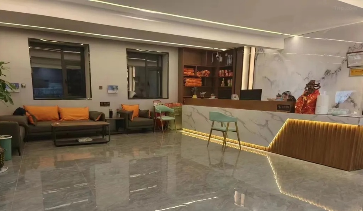 Spacious hotel lobby with marble front desk at Letu Hotel