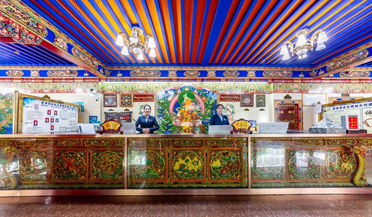 Front desk reception counter with ornate Tibetan wood carvings