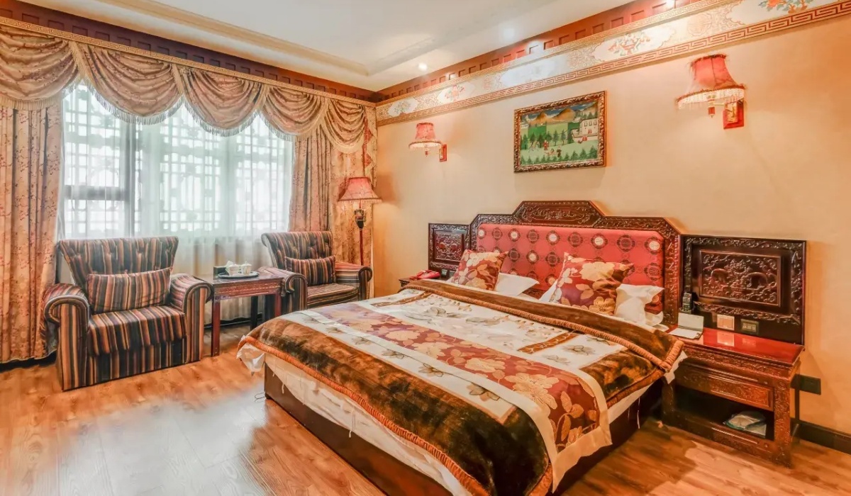Deluxe guest room with comfortable bed and Tibetan accents