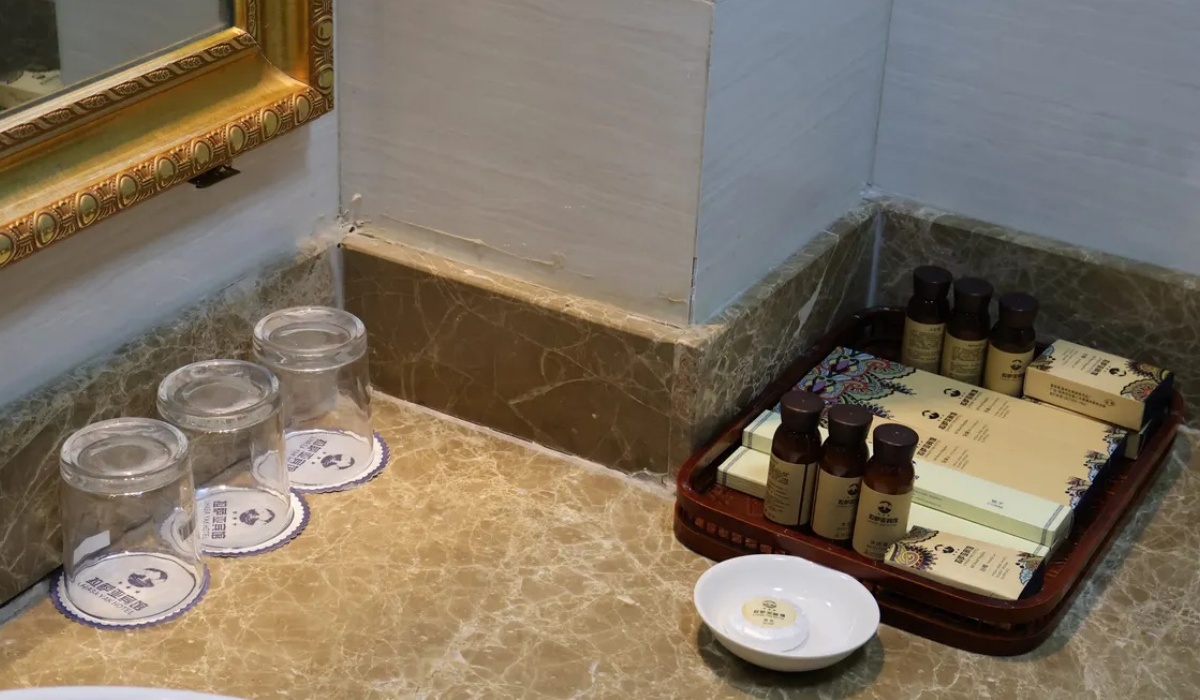 Sink counter and toiletries in a bathroom at Lhasa Yak Hotel