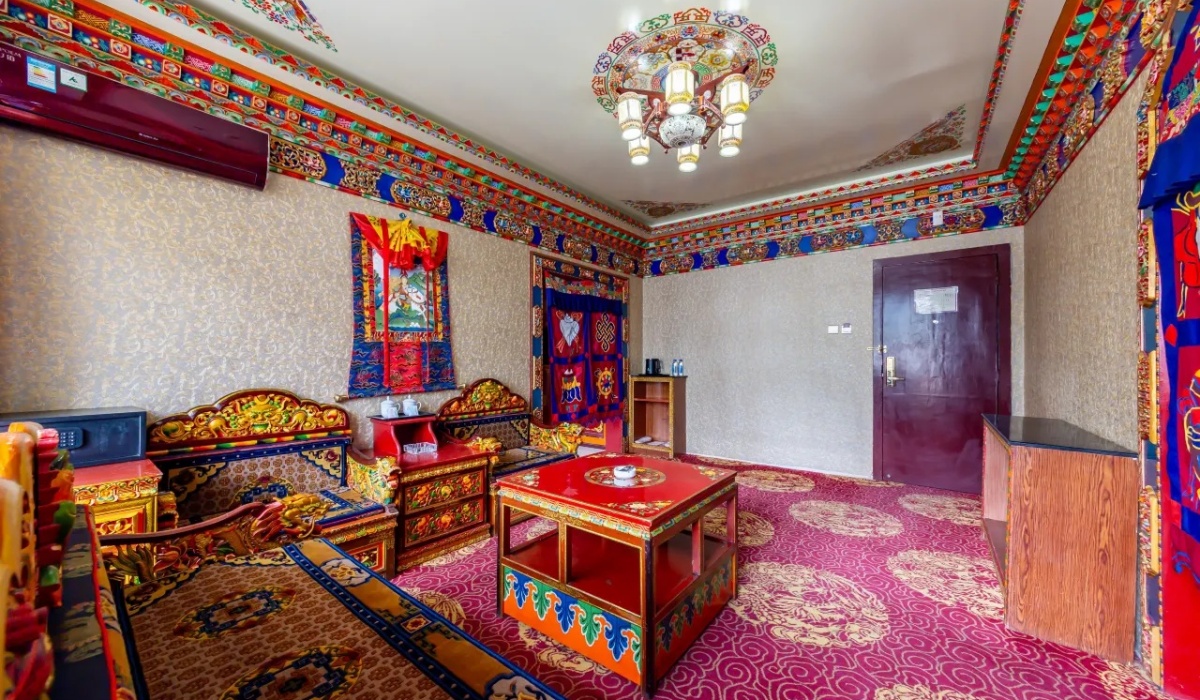 Spacious Tibetan family room with traditional carpets and carved furniture