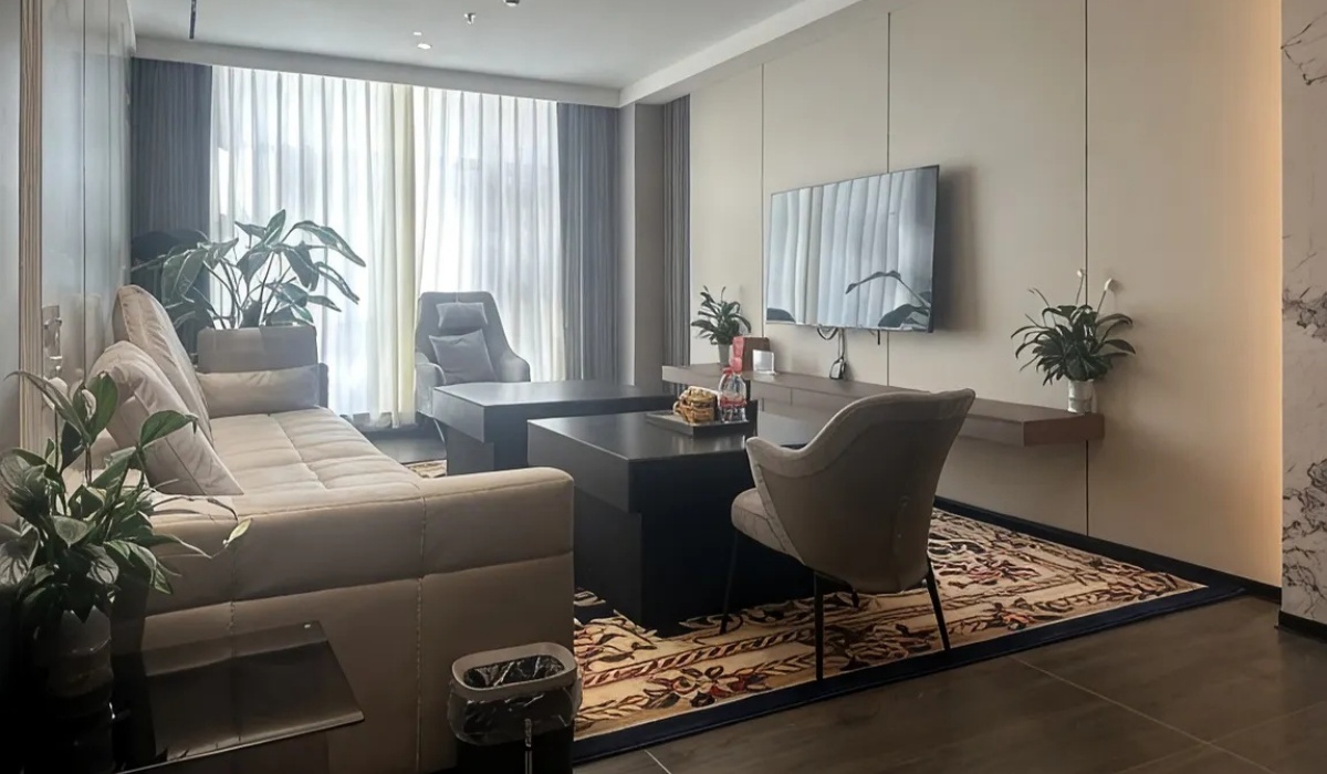 Cozy suite living area with comfortable sofa at Western Inn Sheli Hotel
