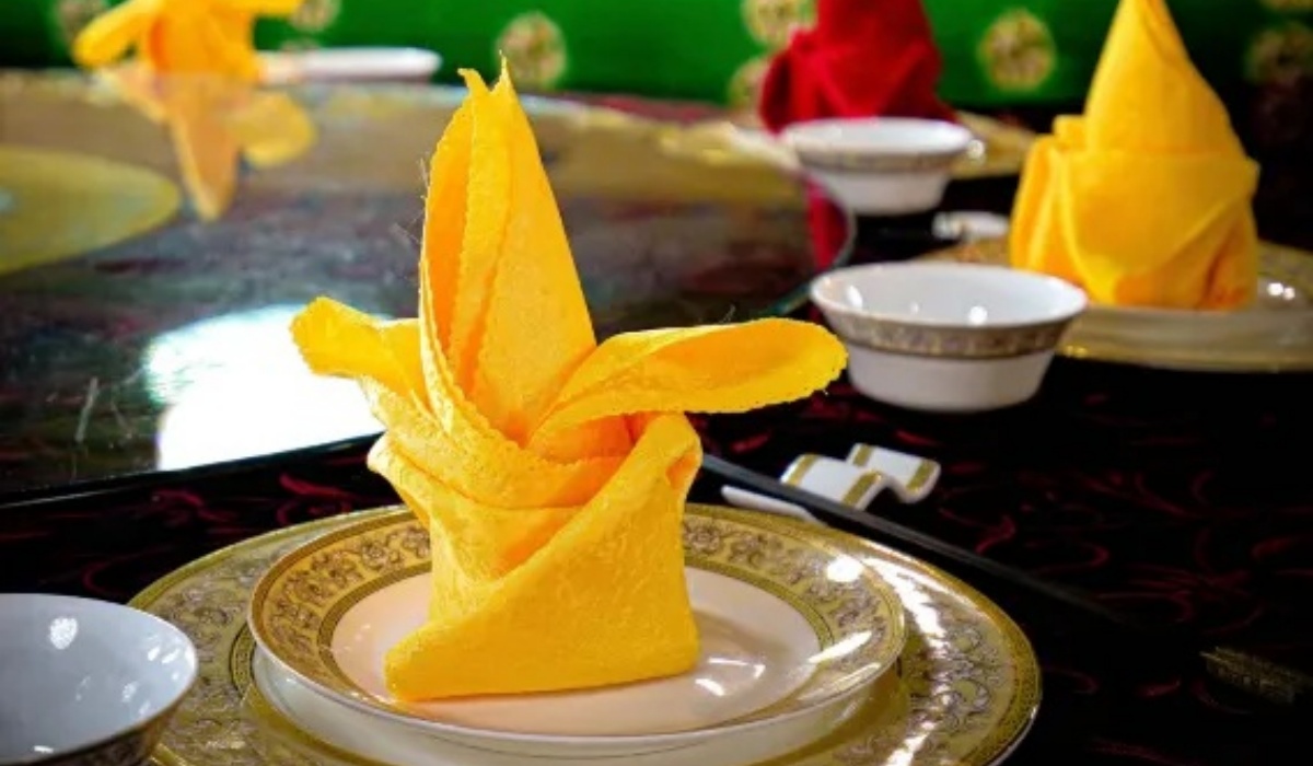 Elegant dining table setting with folded napkins