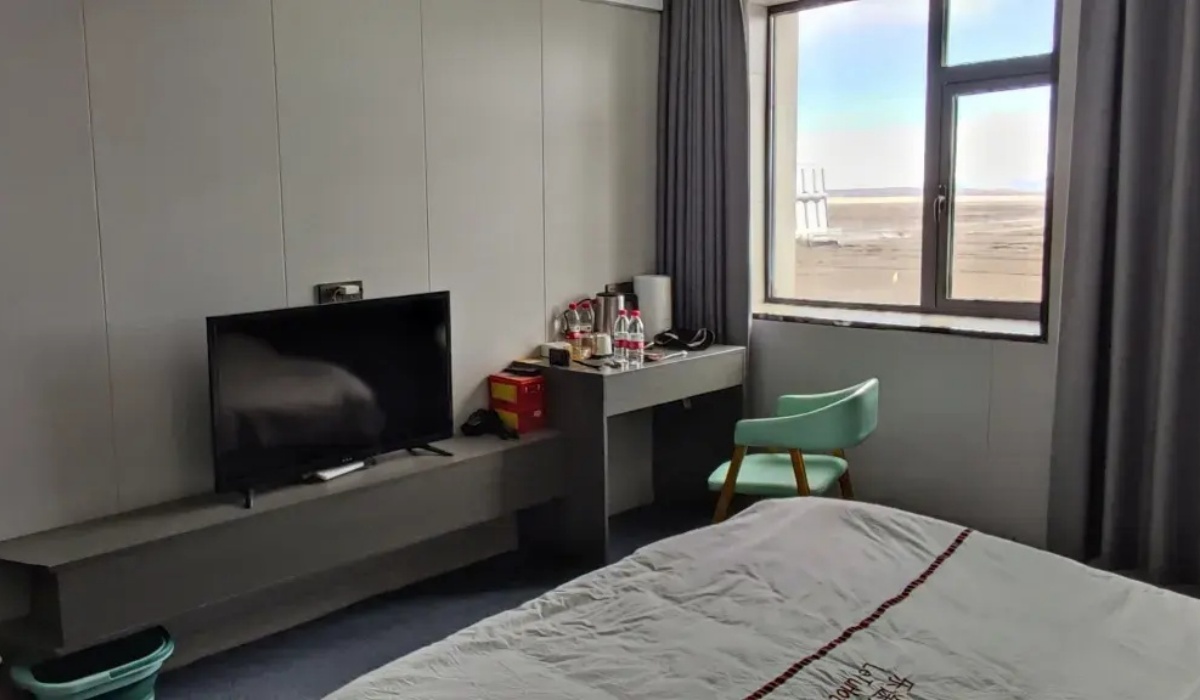 Guest room interior with TV and desk at Letu Hotel